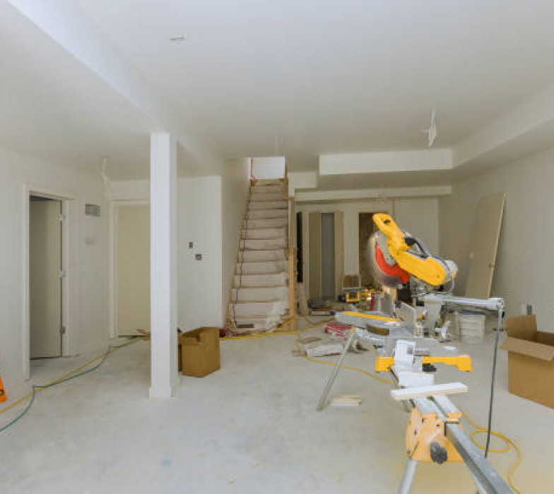 Construction remodeling home with close up of circular saw cutting wood trim molding